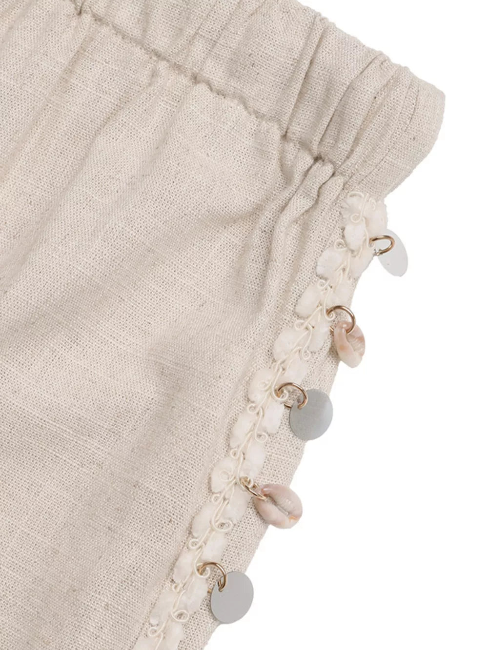 Relaxed drawstring wide-leg trousers in natural linen with shell and disc embellishments.