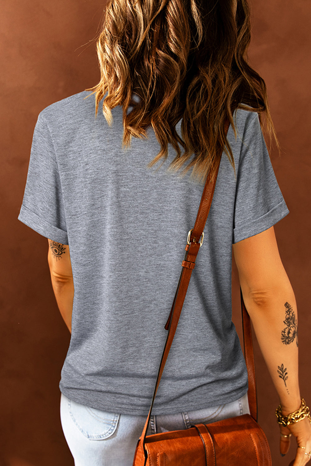 Dark gray t-shirt with short sleeves and a watercolor bow print.