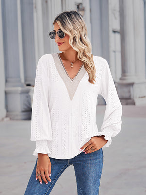 White eyelet lace inset blouse with blouson sleeves and ruffled cuffs.
