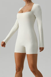 Sculpted square neck ivory long sleeve unitard with short legs.