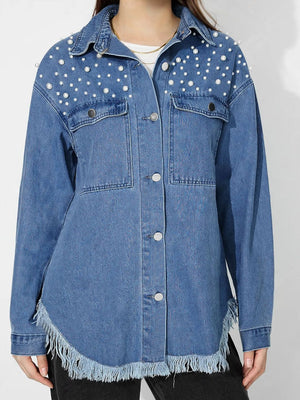 Medium wash denim shirt with pearl embellishments and frayed hem.
