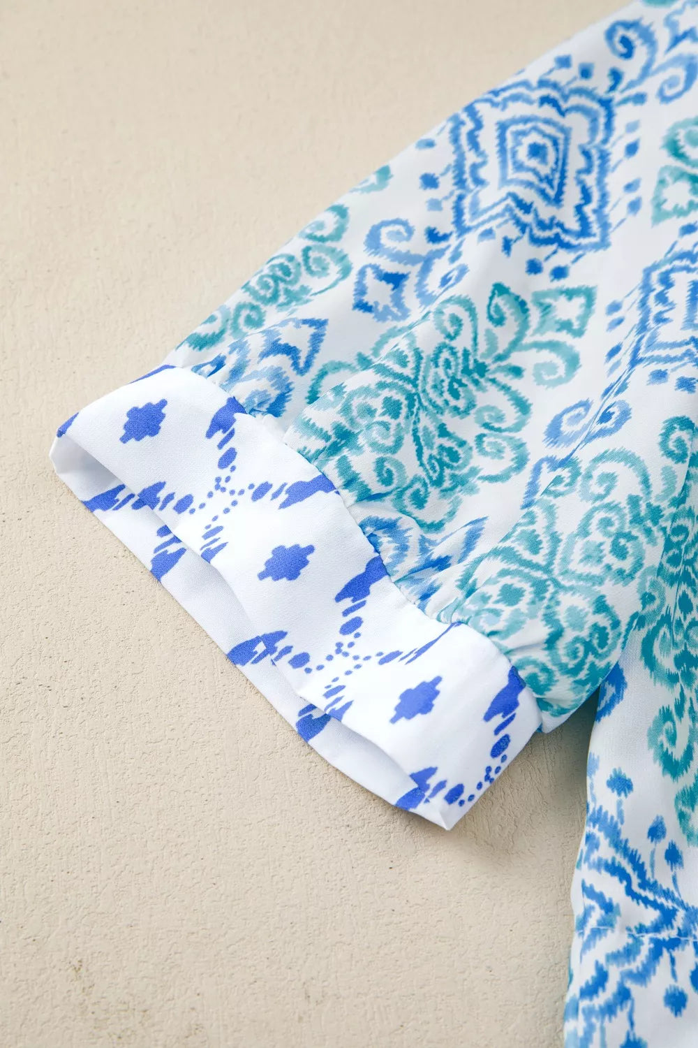Patchwork babydoll shirt with puff sleeves in blue and white ikat print.