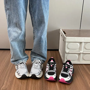 Chunky mesh runner sneakers in silver and hot pink with black accents.