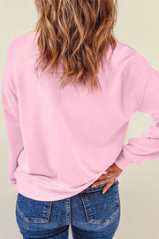 Blush pink sweatshirt with embellished detail on the back, crew neck, long sleeves.