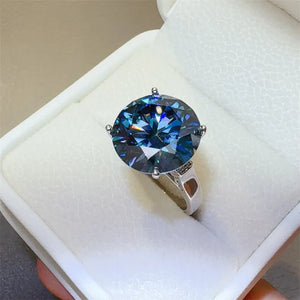 Silver moissanite statement ring with a large, brilliant blue gemstone.