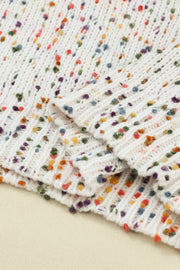 Speckled knit sweater in cream with colorful flecks and puff sleeves.