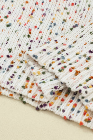 Speckled knit sweater in cream with colorful flecks and puff sleeves.