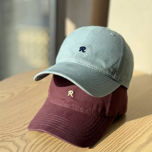 Embroidered letter baseball cap in light blue and burgundy with adjustable strap