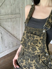 Chic leopard print denim overall dress with adjustable straps and buckle detail.