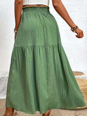 Textured tiered maxi skirt in matcha green with a ruffled waist and subtle vertical texture.