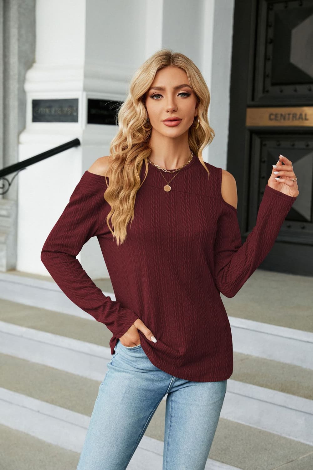 Textured knit cold-shoulder top in wine with long sleeves and a crew neck.