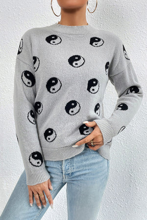 Light gray acrylic knit sweater with all-over black yin yang pattern and mock neck.