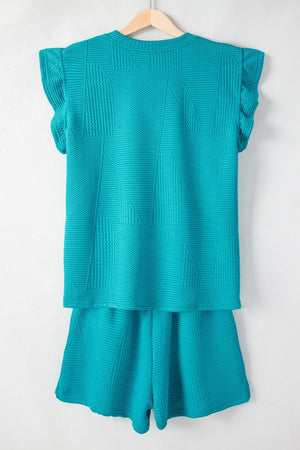 Turquoise textured co-ord short set with flutter sleeves and geometric pattern.
