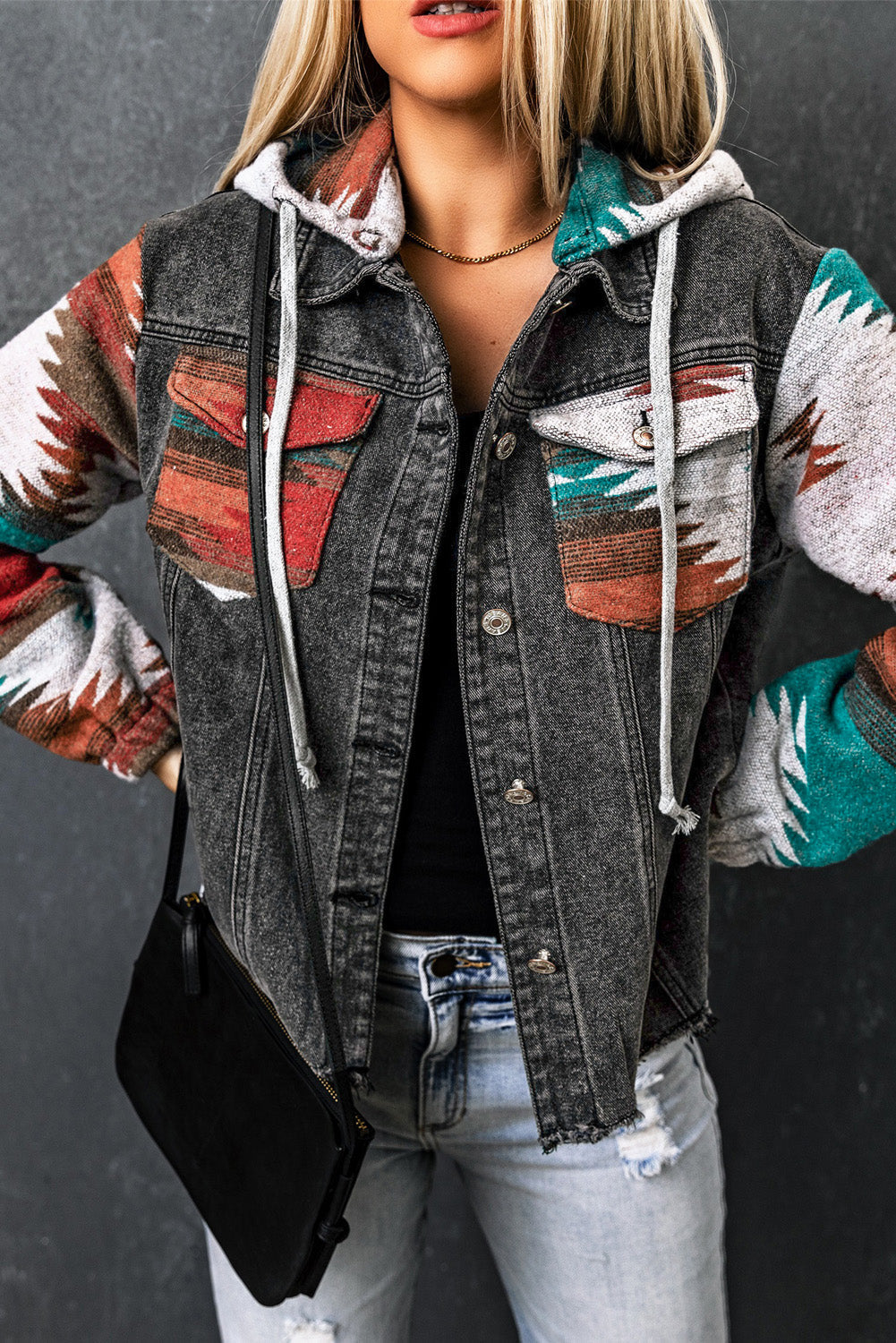 Southwestern print denim hoodie jacket in dark gray with colorful geometric sleeves and pockets.