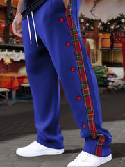 Royal blue sweatpants with plaid trim and snap buttons down the side.