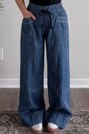 Dark striped wide-leg maternity jeans with drawstring waist and front pockets.