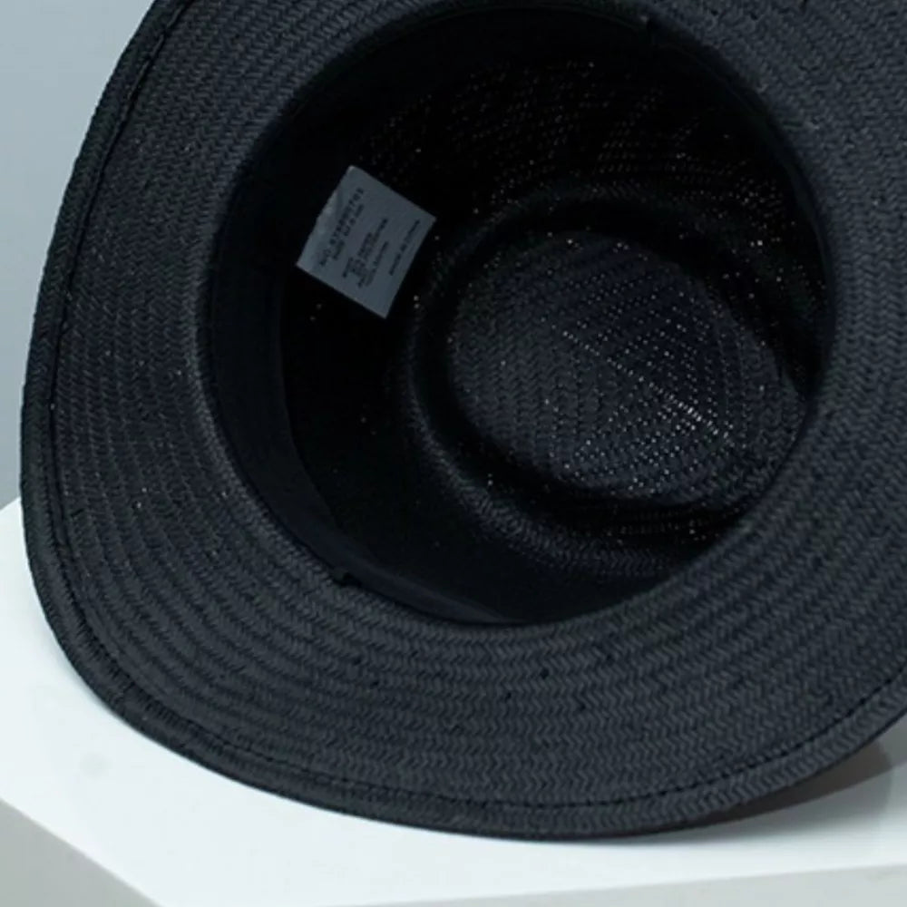 Black straw boater sun hat interior view with woven texture and care label.
