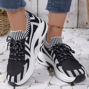 Black and white geometric knit platform sneakers with lace-up closure and chunky sole.