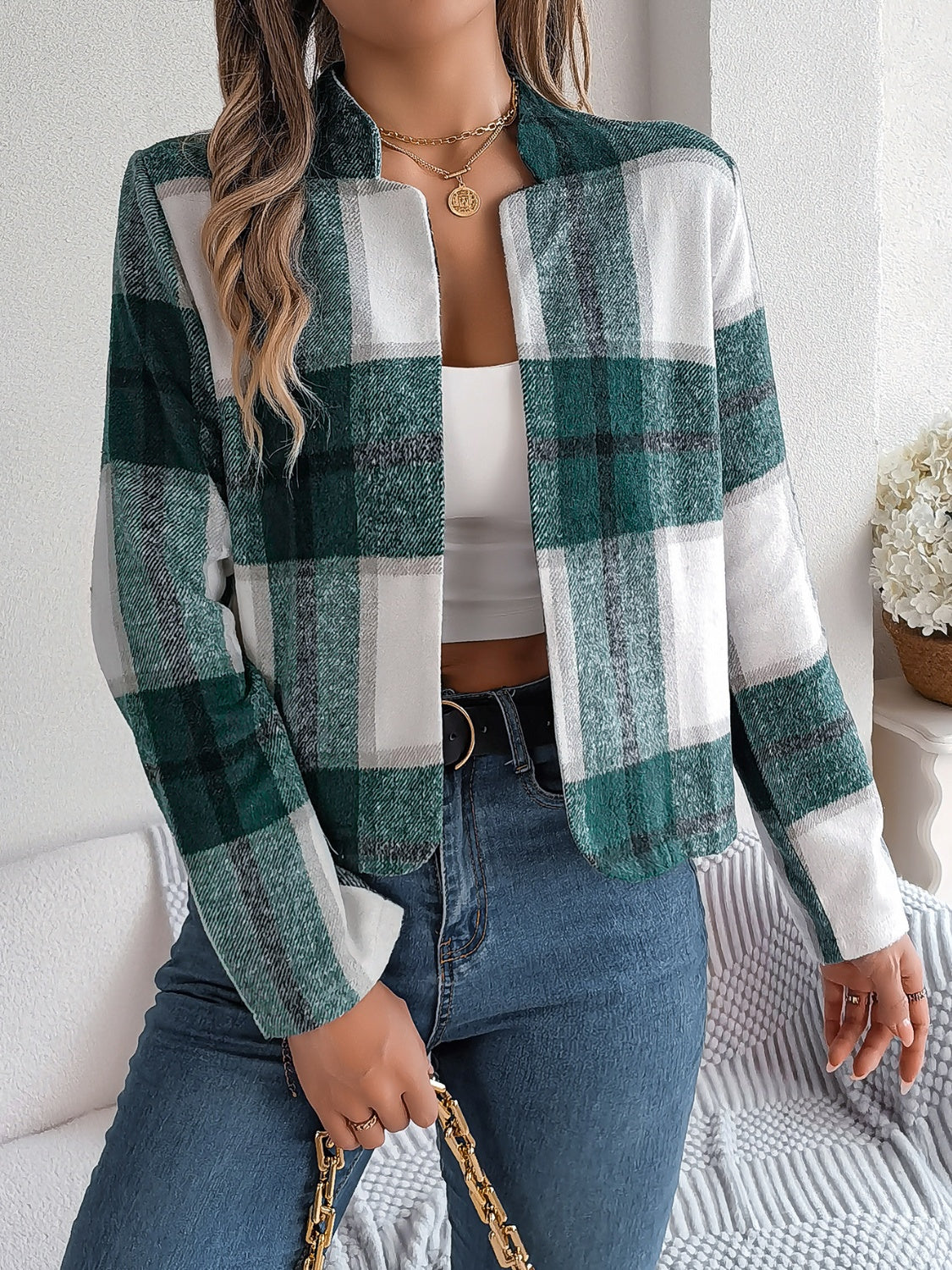 Collarless plaid cropped jacket in dark green with white and grey checks.