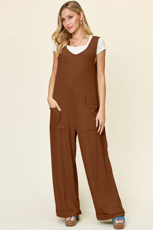 Ribbed knit jumpsuit in Caramel with tie straps, wide legs, and front pockets.
