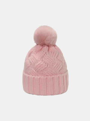 Blush pink cable knit acrylic beanie with a fuzzy pom pom.