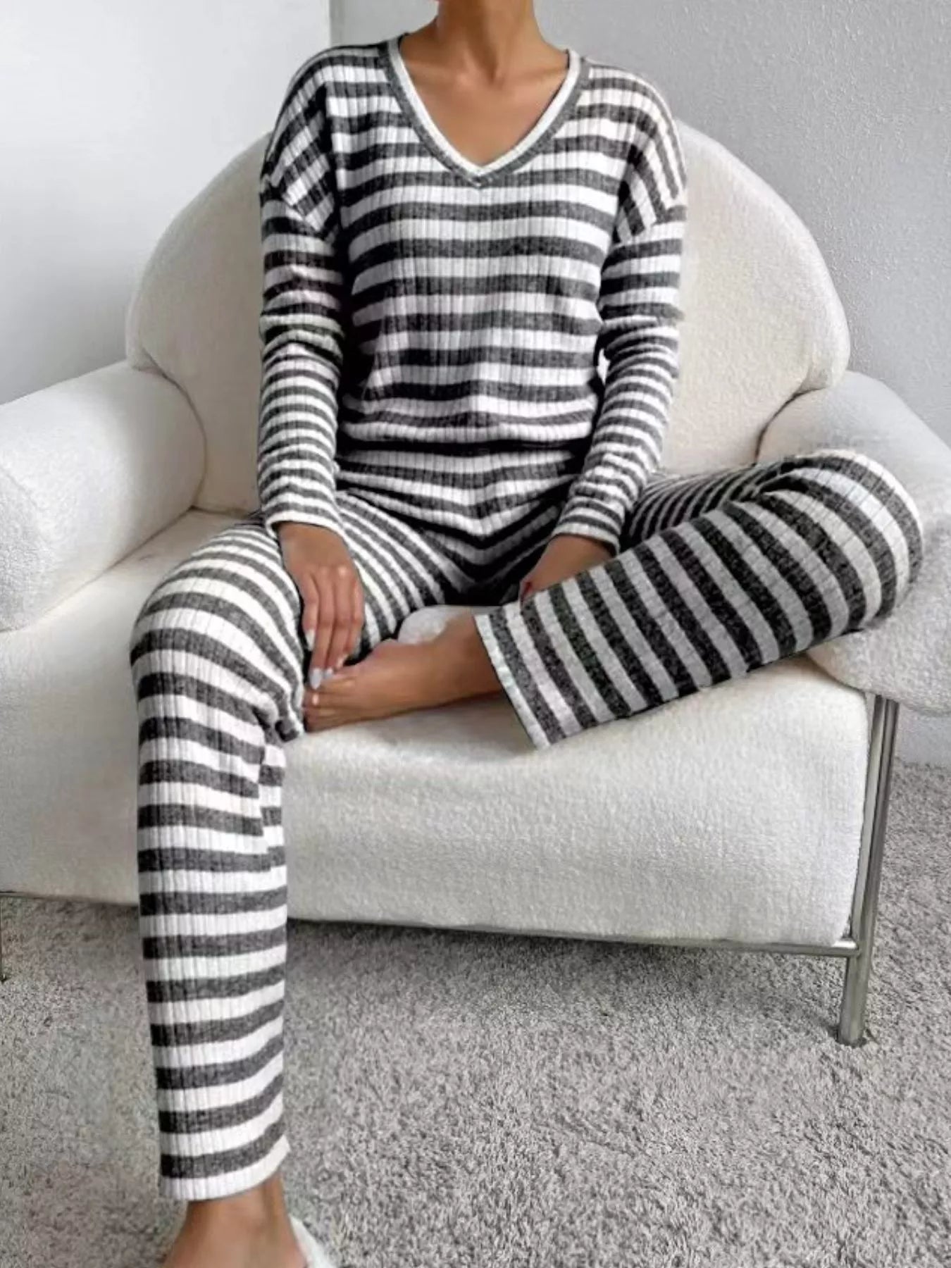Black striped knit loungewear set with V-neck top and long sleeves.
