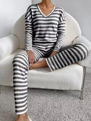 Black striped knit loungewear set with V-neck top and long sleeves.