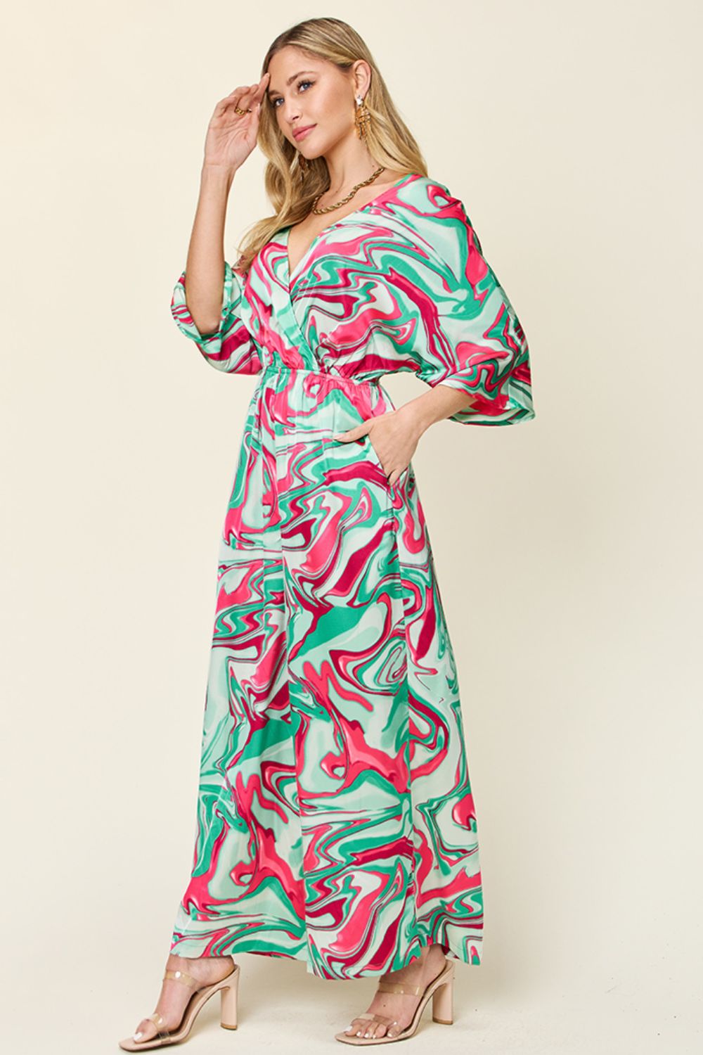 Green swirl print kimono sleeve jumpsuit with a V-neck and wide legs.