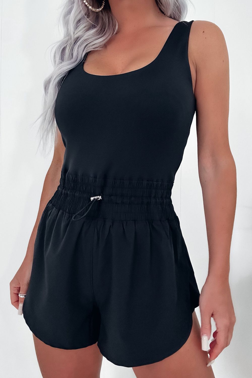 Black tank romper with gathered drawstring waist and short shorts