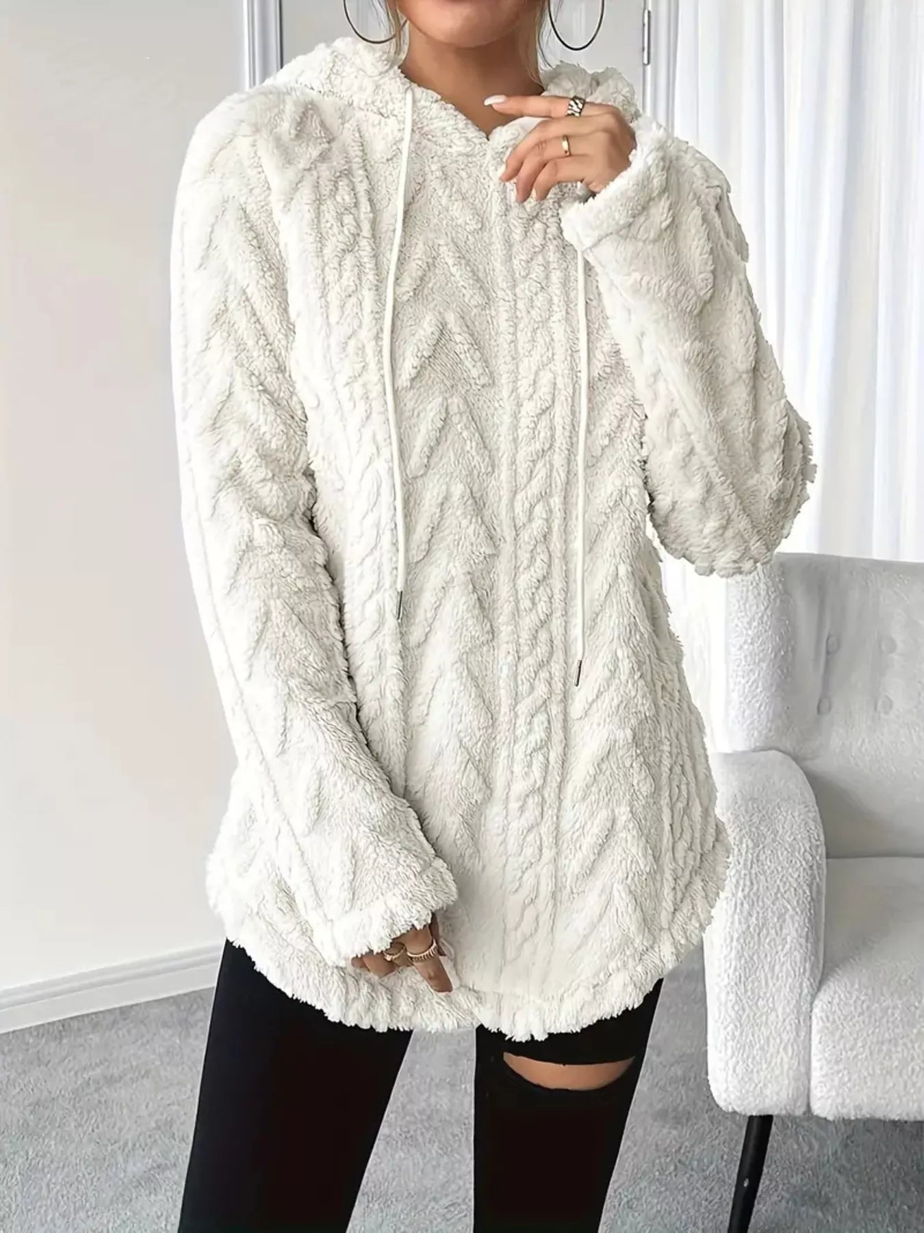 White textured fleece hoodie with cable knit pattern and drawstring hood.