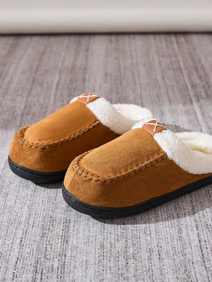 Caramel suede moccasin slides with shearling lining and decorative stitching.