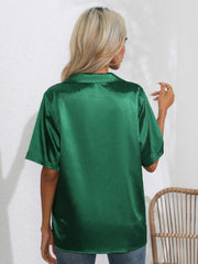 Dark green satin collared shirt with short sleeves, shown from the back.