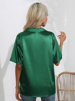 Dark green satin collared shirt with short sleeves, shown from the back.