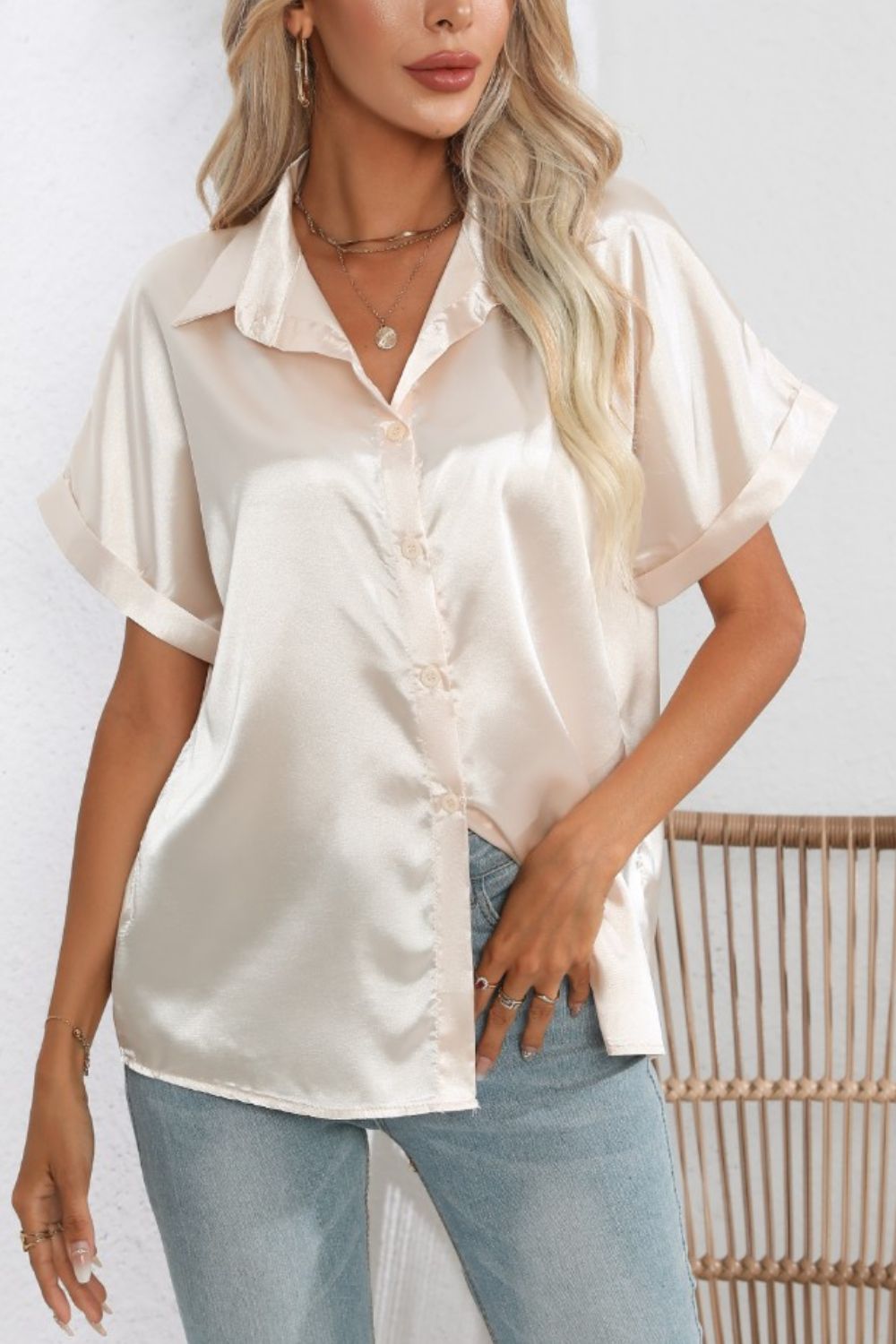Ivory satin cuffed sleeve button-down blouse with a relaxed fit.
