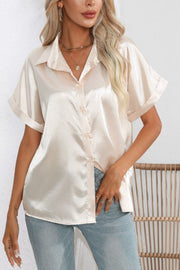 Ivory satin cuffed sleeve button-down blouse with a relaxed fit.