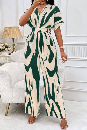 Abstract brushstroke wide-leg jumpsuit in dark green and cream with short sleeves and a V-neck.