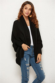 Black textured cocoon knit cardigan with batwing sleeves and shawl collar.