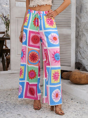 Multicolor geometric print wide-leg drawstring trousers with sun motifs.