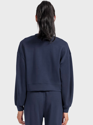 Dark blue cropped crewneck sweatshirt with gathered sleeves and crew neckline.
