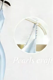 Light blue satin maxi dress with pearl-embellished straps and cowl neck detail.