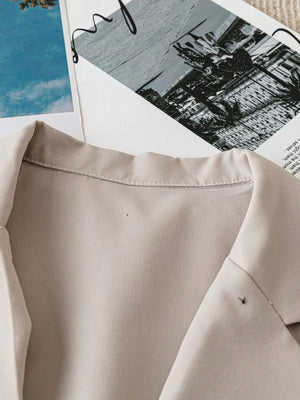 Light Khaki short-sleeve tailored blazer jacket with a classic collar and visible stitching details.