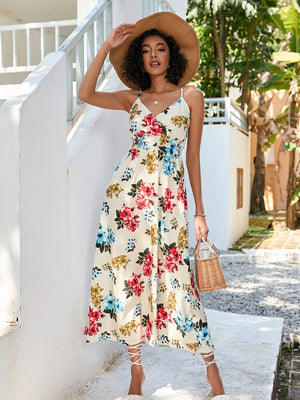 Chic floral midi dress with spaghetti straps, V-neck, and a flowy skirt.