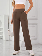 Brown wide-leg lounge trousers with patch pockets and a relaxed fit.
