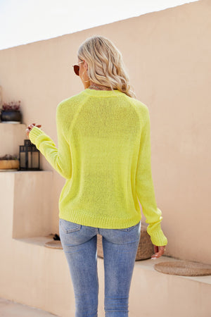 Yellow acrylic knit cardigan with raglan sleeves and button detail.