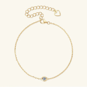 Gold moissanite solitaire chain bracelet with heart charm and lobster clasp.