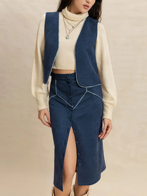 Peacock blue suede vest and button-front skirt set with contrast stitching detail.