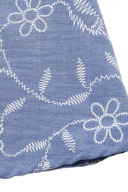 Maxi dress with white floral embroidery on blue textured fabric