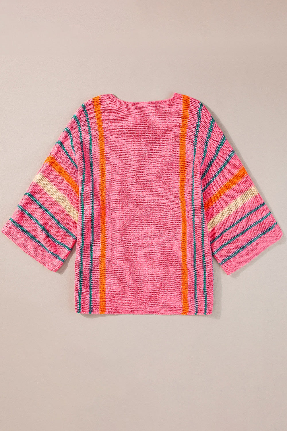 Colorblock sleeve knit pullover in pink with vertical orange and teal stripes and horizontal stripes on sleeves.