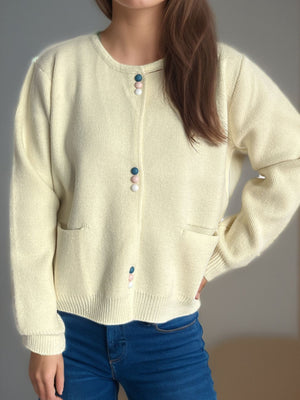 Cream ribbed knit button-up cardigan with colorful dot buttons and pockets