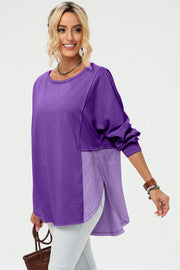 Purple sweatshirt with split-panel design and asymmetric hemline, crew neck, long sleeves.